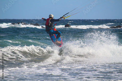 Kite surfer jumping in the waves of the Atlantic ocean