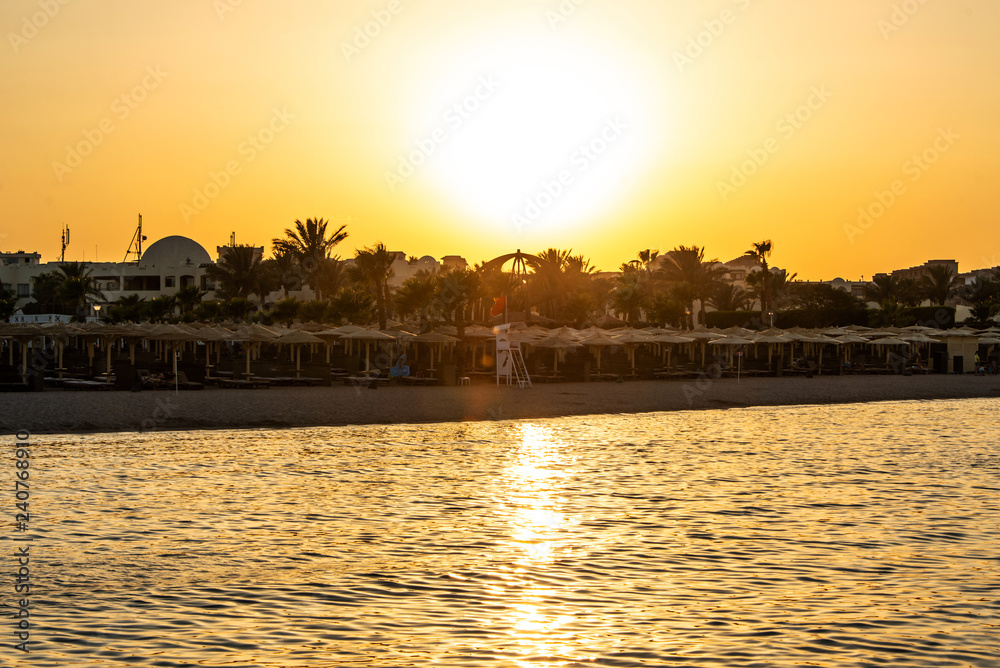 Sunset over the red sea palm tree silhuettes hotel in Makadi Bay Egypt