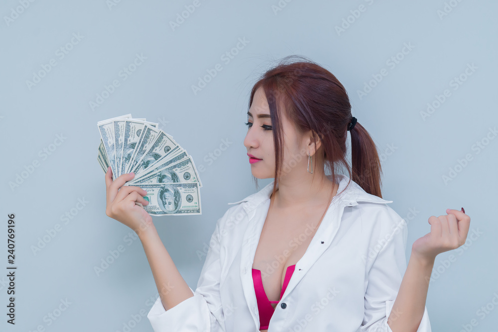 Portrait of asian sexy woman with a lot of money on white background,thailand people,The rich business woman concept Portrait of asian sexy woman with a lot of money on white background,thailand people,The rich business woman concept