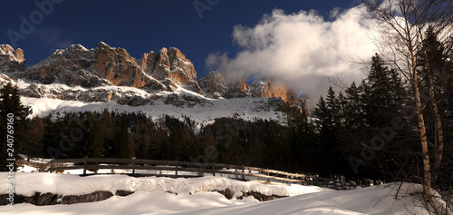 Beautiful Dolomites winter landscape at Passo of Costalunga with the Mountains Group of Catinaccio on the background, Trentino Alto-Adige, Northern Italy.