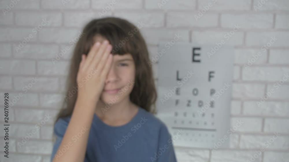 Happy child at ophthalmolog examination. A little girl checks her eyesight with an ophthalmologist. Happy child at ophthalmolog examination. A little girl checks her eyesight with an ophthalmologist.