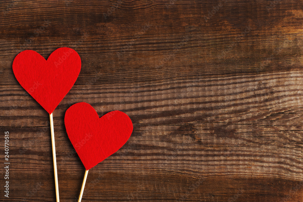 Red hearts on a wooden table. Blank or greeting card background for Valentine's Day. Place for text, copy space. Red hearts on a wooden table. Blank or greeting card background for Valentine's Day. Place for text, copy space.