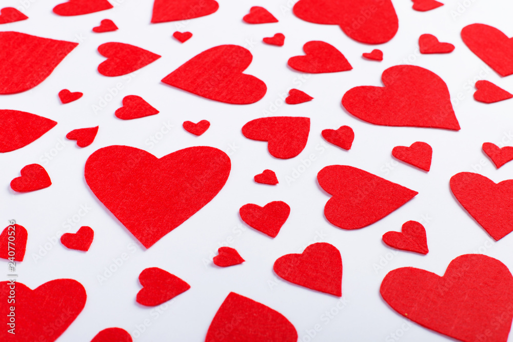 Red hearts of different sizes on a white background. Harvesting cards for Valentine's Day. Red hearts of different sizes on a white background. Harvesting cards for Valentine's Day.