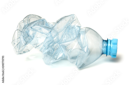 closeup of plastic bottle crushed for recycling on white background