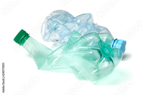 closeup of plastic bottles crushed for recycling on white background