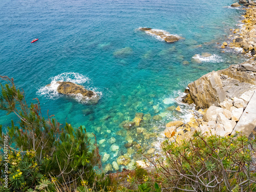 Elevated Cinque Terre National Park Mediterranean Sea coastline view with a boat in the distance, Cinque Terre, Liguria Italy
