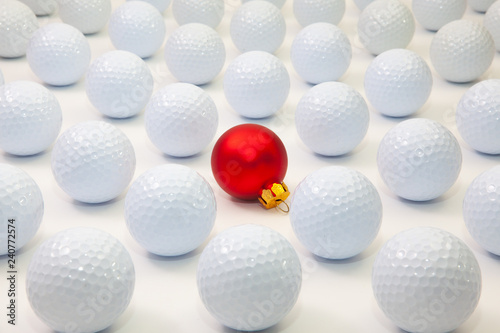 Pattern with white golf balls and red Christmas decoration