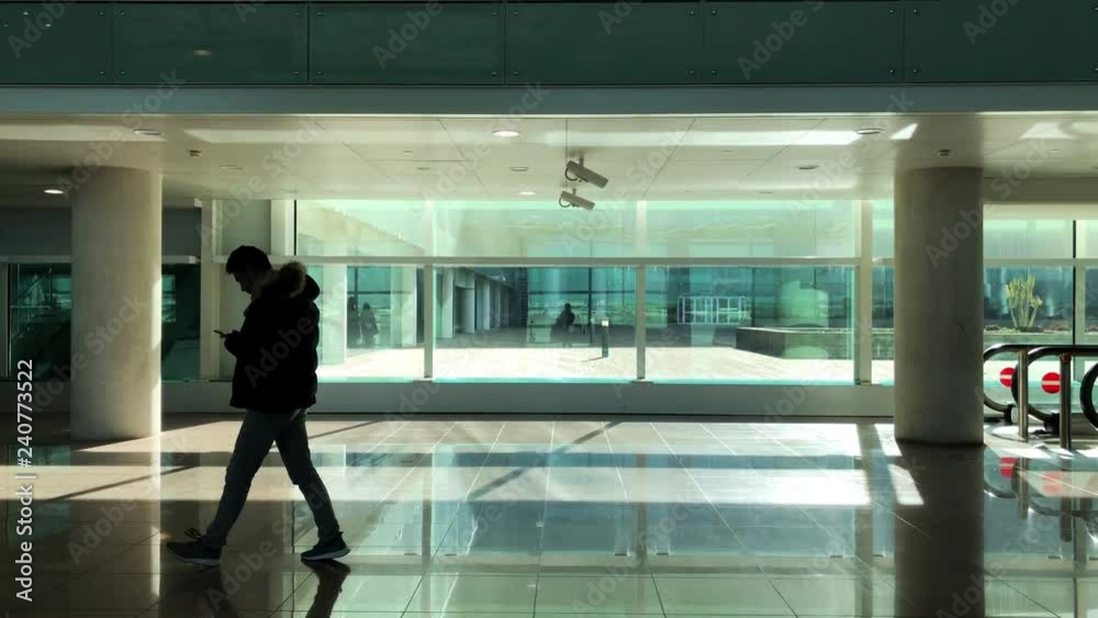 Man walking down airport terminal Man walking down airport terminal