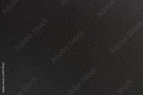 The texture of the surface of black stone. Grunge backdrop with space for text or image. Black and dark background.