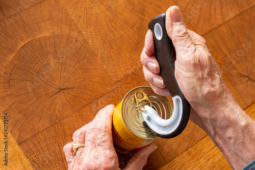Man opening a tin can with a special tool