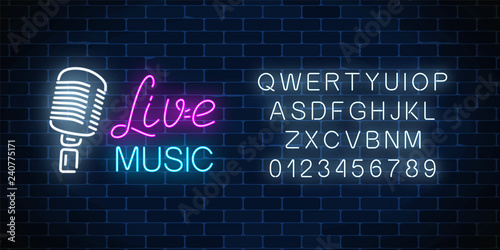 Neon alphabet and signboard of nightclub with live music. Glowing street sign of bar with karaoke and live singers.
