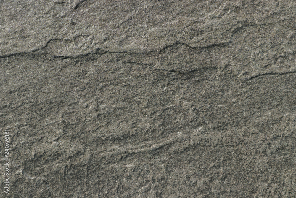 The texture of a dark gray stone with a rough and matte surface. Grunge background with space for text or image. Grey backdrop. The texture of a dark gray stone with a rough and matte surface. Grunge background with space for text or image. Grey backdrop.