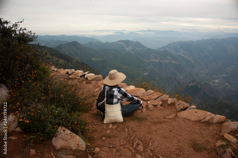  Person meditating in the chasm of the mountain four sticks in Mexico with a view to the Sierra Gorda