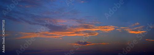 Beautiful sky with clouds at sunset with airliner photo