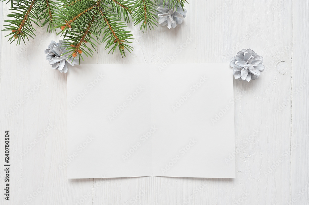 Empty white sheet of paper on a white Christmas background of fir branches and cones. Letter To Santa, mockup Empty white sheet of paper on a white Christmas background of fir branches and cones. Letter To Santa, mockup