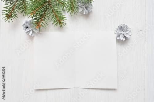 Empty white sheet of paper on a white Christmas background of fir branches and cones. Letter To Santa, mockup