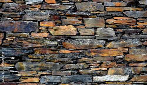 Quadro su tela Close-up detail view of an old traditional stone wall built from schist in Piodão, made of shale rocks stack, one of Portugal's schist villages in the Aldeias do Xisto