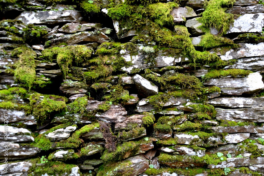 Close-up detail view of an old traditional stone wall built from schist in Piodão, made of shale rocks stack, one of Portugal's schist villages in the Aldeias do Xisto.