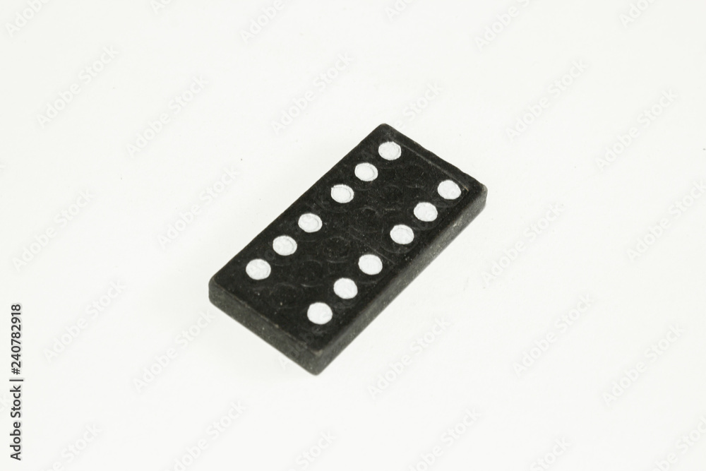 Single black domino stone on white background. Single black domino stone on white background.