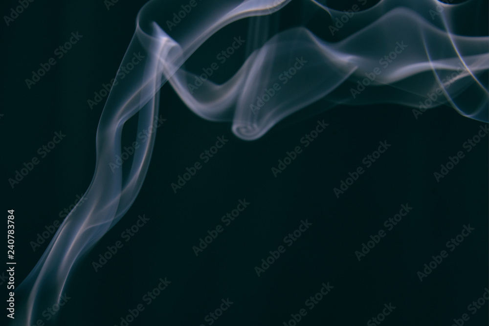 smoke wriggles around in different patterns on a black background.
