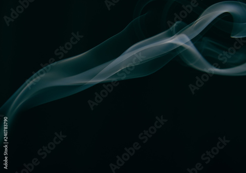 smoke wriggles around in different patterns on a black background.