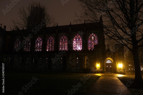 Outside view on a cold wet night of the stained glass windows of the All Saints Chapel at The University of the South in Sewanee, Tennessee. photo