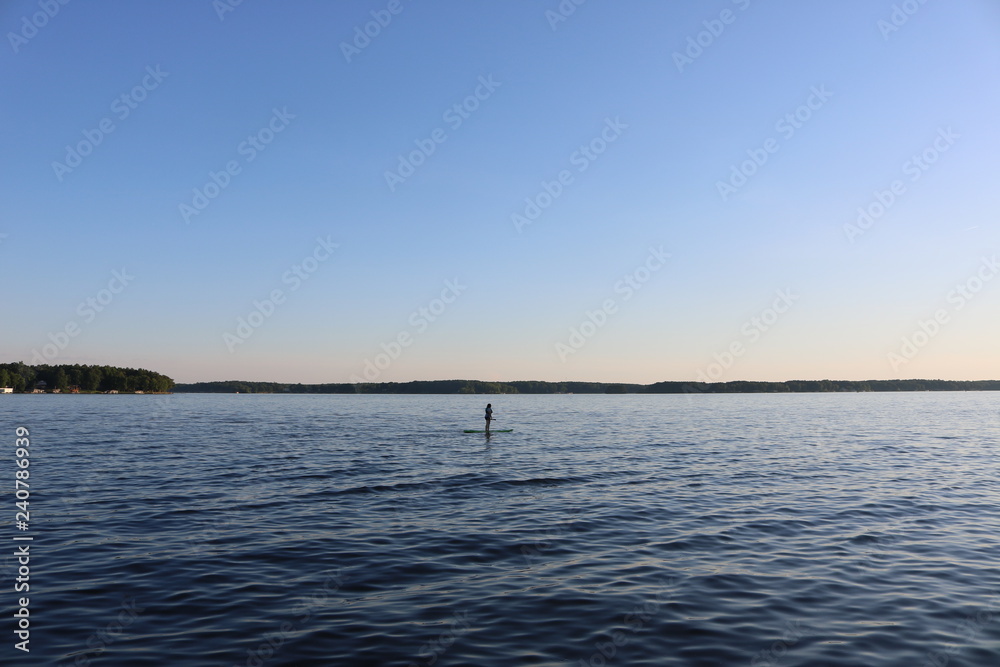 Woman on a paddle board on a lake