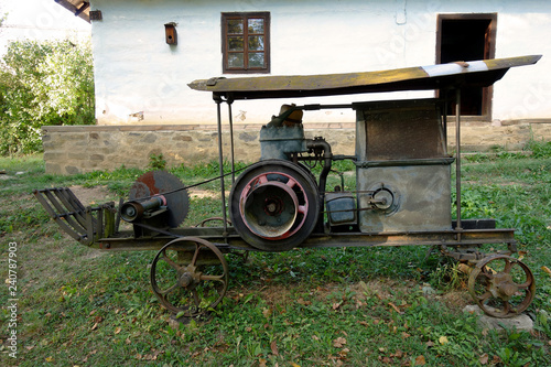 An old motor saw on wheels