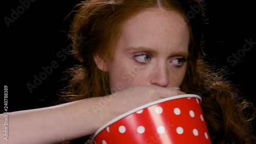 Bulimic woman eating popcorn photo