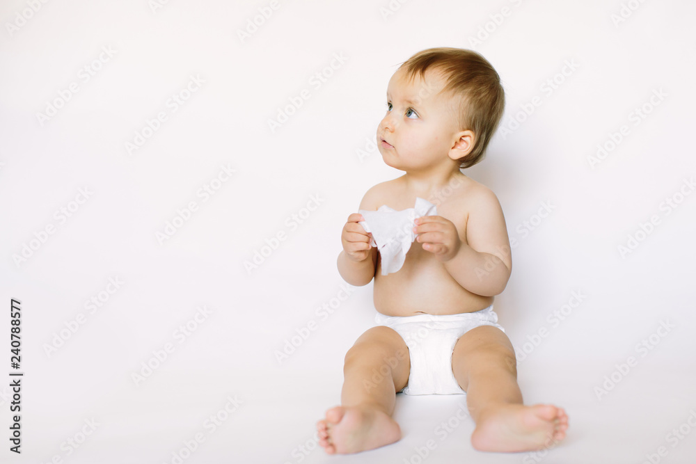 Hygiene - little baby girl get wet wipes, and wipes her face isolated on white background. Cleaning wipe, pure, clean