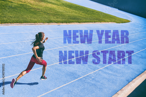 New Year resolution fitness concept. New Year New Start athlete runner sprinting on blue race tracks racing to the finish line in goal achievement challenge. Starting life change woman.
