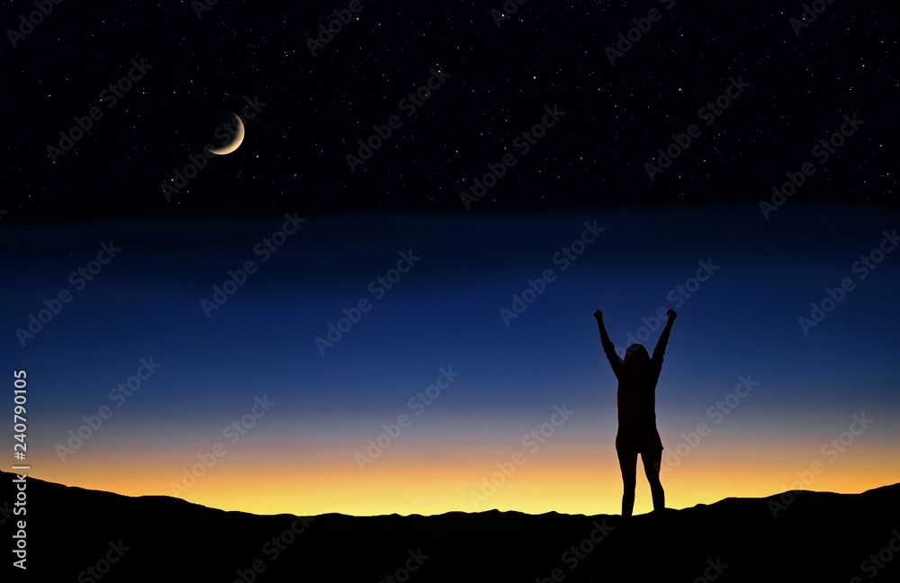 Person with raised arms silhouetted against the sunset and crescent moon.