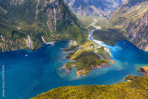 New Zealand. Milford Sound (Piopiotahi) from above - the head of the fiord with wharf and Milford Sound Airport. There is Cleddau River in the background