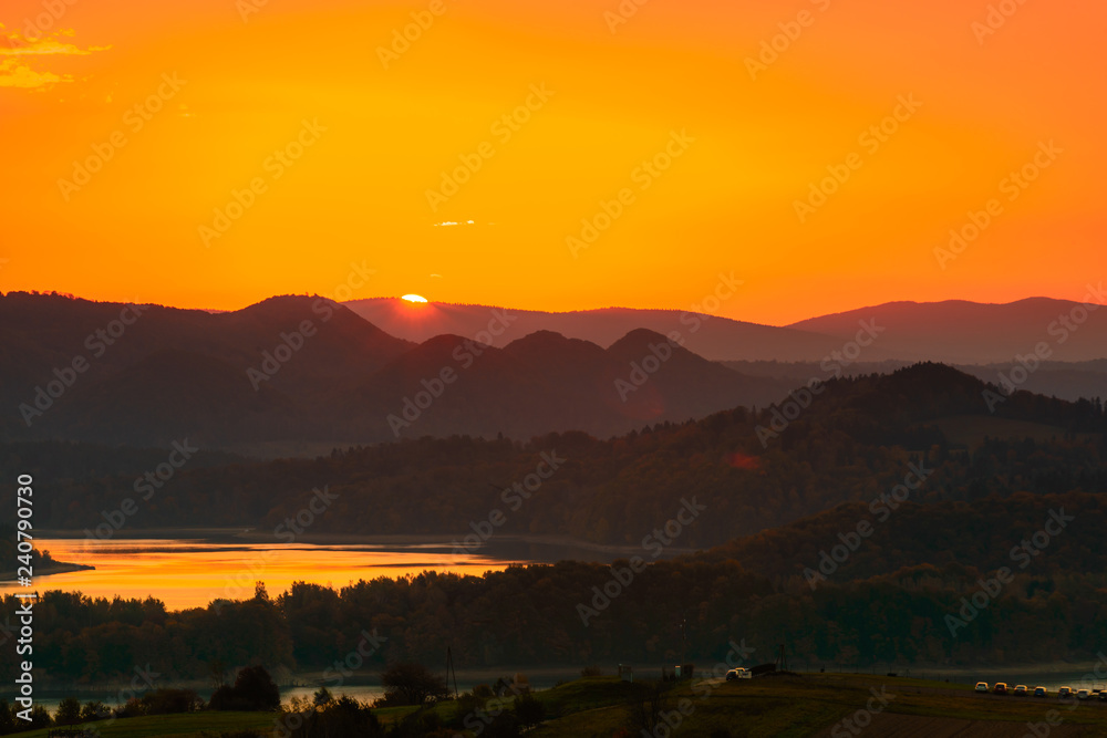 Fototapeta premium Polanczyk, Bieszczady Mountains, Poland: Sun rising over Solina Lake. Views from near hill.