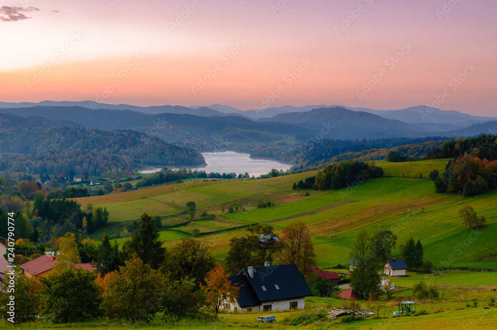 Fototapeta premium Polanczyk, Bieszczady Mountains, Poland: Sun rising over Solina Lake. Views from near hill.