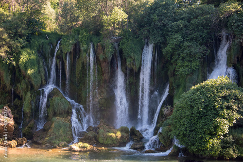 Popular with tourists Kravica waterfall is a large tufa cascade on the Trebi  at River  in the karstic heartland of Herzegovina in Bosnia and Herzegovina