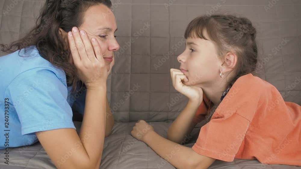 A child with his mother are opposite each other. Lovely mother and daughter look into each other's eyes. A child with his mother are opposite each other. Lovely mother and daughter look into each other's eyes.