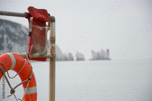 Lifebelt and emergency gear with the Needles, Isle of Wight, in background photo