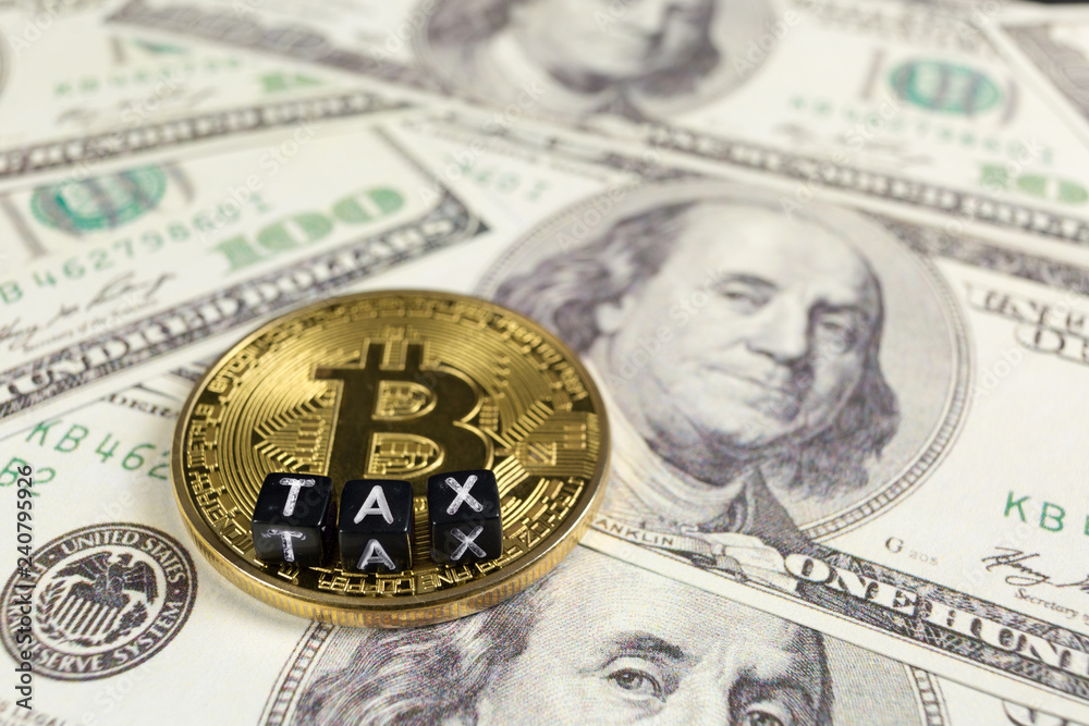 Cryptocurrency Bitcoin on a Dollar bills. Tax paying concept. Cryptocurrency Bitcoin on a Dollar bills. Tax paying concept.