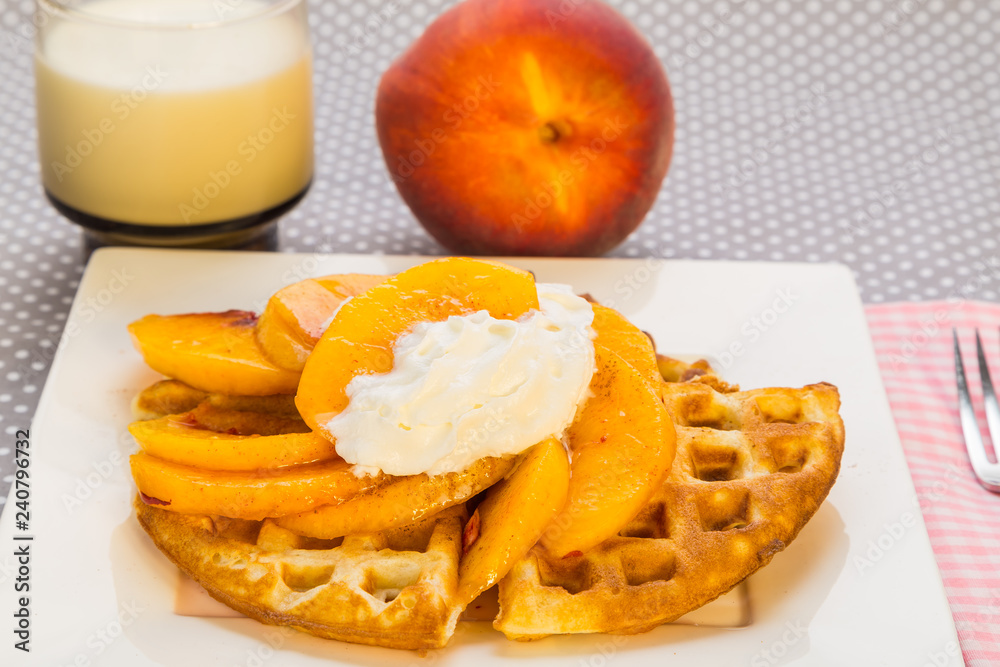 Peaches and Whipped Cream on Waffle with Glass of Cold Milk Peaches and Whipped Cream on Waffle with Glass of Cold Milk