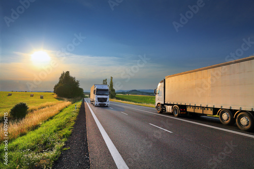 Truck transport on the road at sunset and cargo