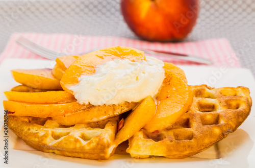Peaches and Whipped Cream on Golden Brown Waffles