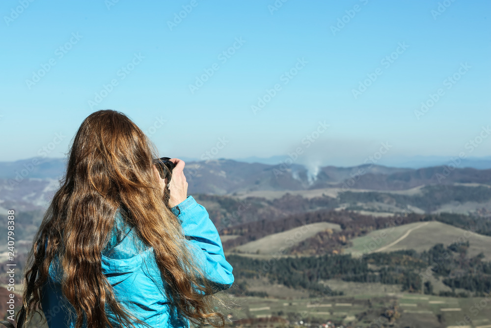 Professional nature photographer taking photo of mountain landscape
