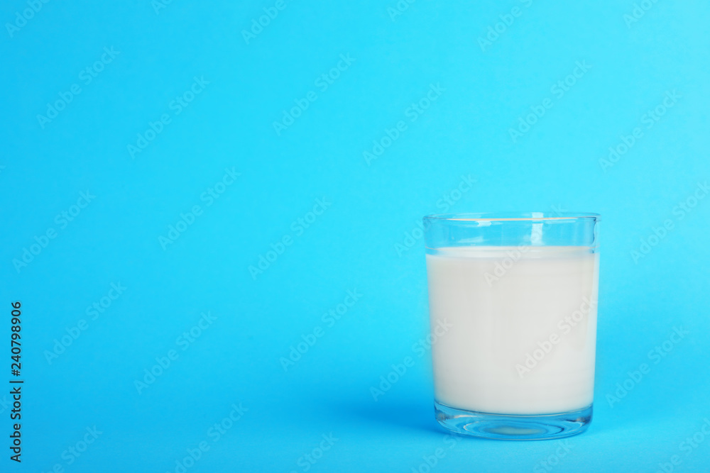 Glass with fresh milk on color background. Space for text Glass with fresh milk on color background. Space for text