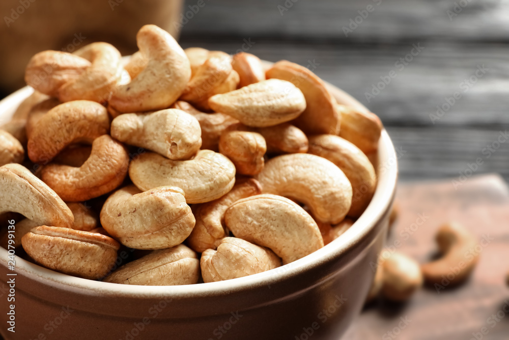 Bowl with cashew nuts on table, closeup Bowl with cashew nuts on table, closeup