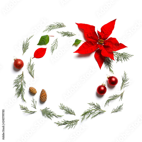 Flat lay composition with poinsettia and space for text on white background. Traditional Christmas flower