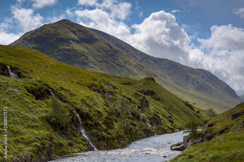 River flows past mountain at Glen Etive in the Scottish highlands photo