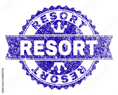RESORT rosette stamp watermark with distress style. Designed with round rosette, ribbon and small crowns. Blue vector rubber watermark of RESORT caption with unclean style.