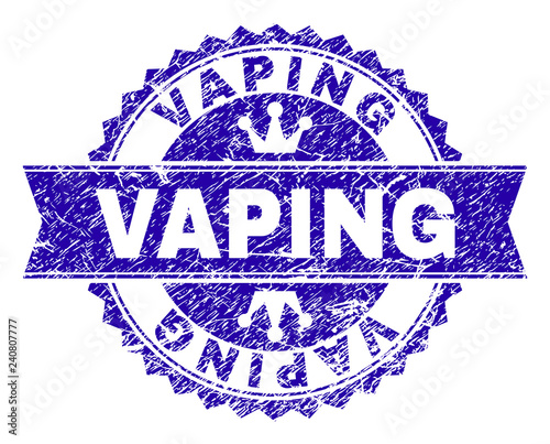 VAPING rosette stamp seal watermark with grunge texture. Designed with round rosette, ribbon and small crowns. Blue vector rubber print of VAPING label with grunge texture.