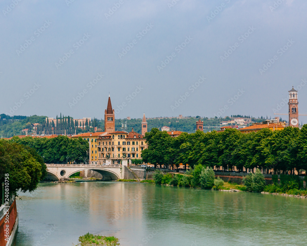 Adige river by the historical center of Verona, Italy, with towers and architecture